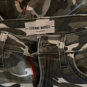 Camo skinny jeans with ankle zippers and red seems